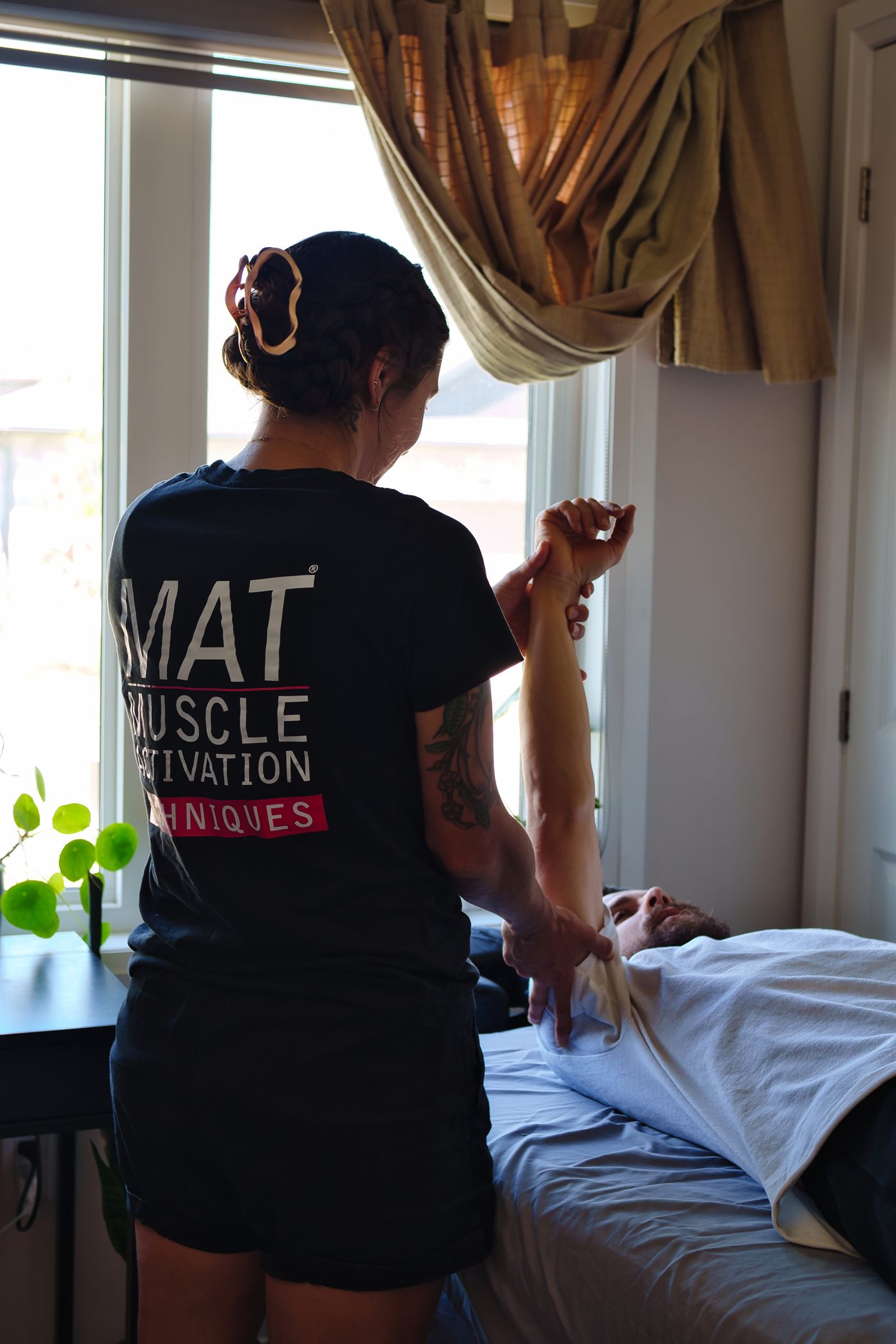 Livv performing Muscle Activation Techniques on a client during an in-home session